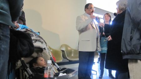 Chaudhry Roouf Ahmad talks to reporters outside his family's deportation hearing on February 16th while his son, Muhammad, looks on. (Photo: Tom MacDonald)