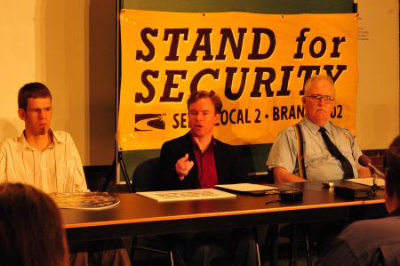 Securitas workers Simon Vigneault (centre) and Michael Anthony (right) speak to members of the media and community at a press conference announcing a union drive to organise security workers in Halifax. Photo by John Benoit.