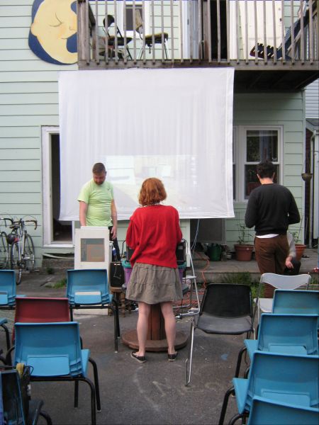 Co-organizer Ella Tetrault helps set up for the night's lecture.