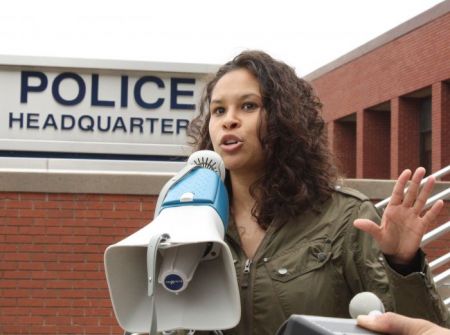 El Jones performs a poem at a protest last summer. The spoken word artist says racism makes it more difficult for women of colour to report rape. Photo by Hilary Beaumont