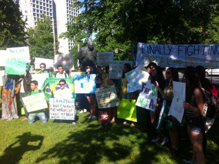  Protesters sing the Brazilian national anthem.  Photo Jon Grant