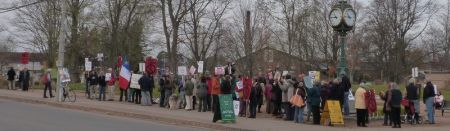 People line up along Main Street, Wolfville on a brisk & busy morning.