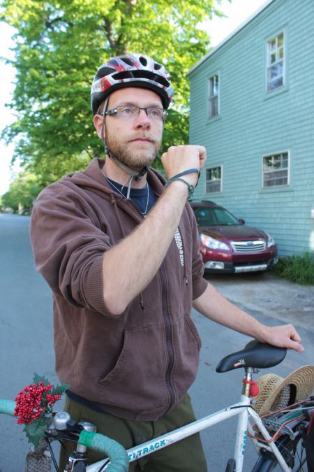 Adrian Martynkiw displays a scrape on his forearm, which he says he received after a bus driver slammed a window on his hand. (Photo by Hilary Beaumont)