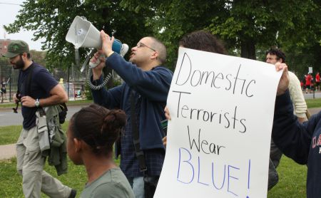 Isaac Saney chants "education, not criminalization" into the megaphone Saturday (Photo: Hilary Beaumont)