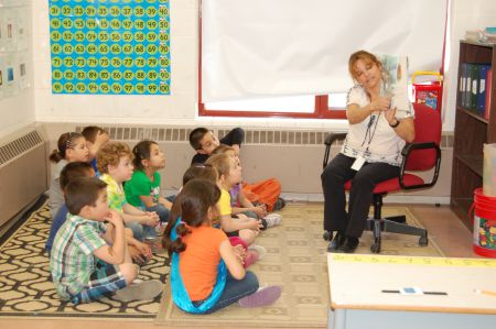 Eskasoni teacher Gail Stevens reads a story in Mi'kmaq to a grade primary class. Photo courtesy of Ida Denny