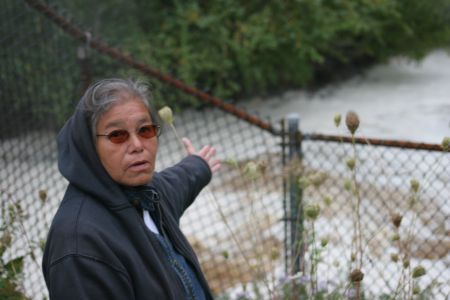 Maurina Beadle stands by the effluent flow from the Abercrombie Mill to the Boat Harbour Treatment System. [Photo: Miles Howe]