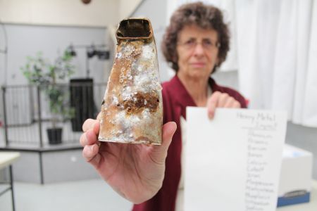 Harrietsfield community member Marlene Brown holds up a faucet rusted away by her toxic water. Concerned residents have been shuffled around various levels of governance. [Photo: R. Hussman]