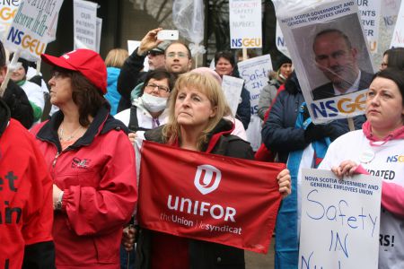 People listen as nurses relate what it is like to work short-staffed.  Photo Robert Devet