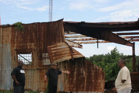 Glinton, Faqi and Garvey Survey a Former Power Generating Station in Eight Mile Rock. [Photo: Miles Howe]