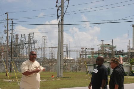 Troy Garvey, Jonathan Glinton and Etienne Farquharson stand in front of the old Grand Bahama Power Station. Critics say the old plant could have been retrofitted for a fraction of the $80 million Emera recently spent on building a new power station, where allegations of union busting are rampant (Miles Howe photo).