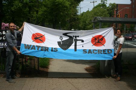 About 20 people gathered in downtown Halifax to show solidarity with the residents of Pictou Landing First Nation and their battle for clean air and water. Photo Robert Devet