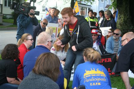 President of the Halifax-Dartmouth & District Labour Council Kyle Buott leads the crowd in a particularly energetic chant.  Photo Robert Devet