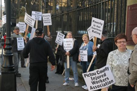 Demands for a Royal Commission inquiry into workers comp was the word of the day outside Legislature House in Halifax. [Photo: Miles Howe]