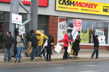 About 80 people employed in the industry rallied this morning at the Armdale Rotary. Many workers fear cuts to the Film Tax Credit program will force them to leave the province. Photo Robert Devet