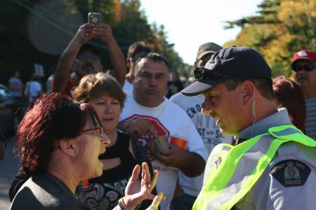 Tempers flared after Clair was struck by a police cruiser. [Photo: Miles Howe]