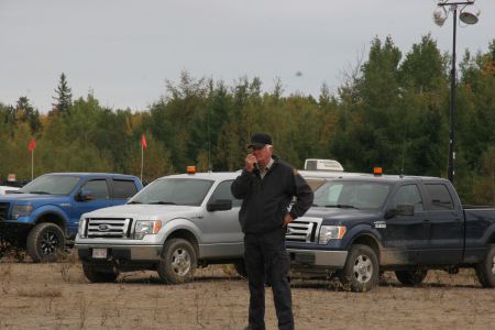 Why did this Industrial Security Limited employee approach a sacred fire, while armed, on October 15th? [Photo: Miles Howe]