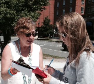 Another person sign a letter to Harper, I'm holding the clipboard