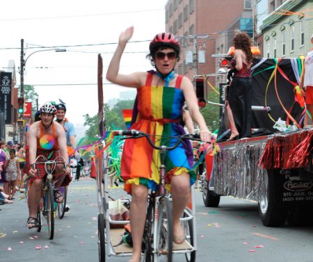 Megan Leslie rides her bike during a pride parade in Halifax (Photo by Gwyneth Dunsford).