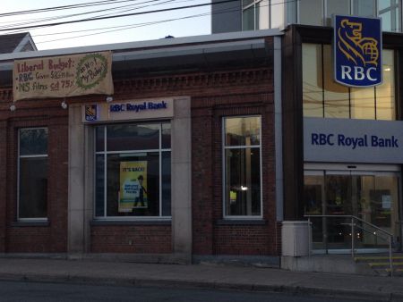 $22 million of taxpayers' money for RBC, but no money for the poor, students, or even for dental work for children. That's wrong, says a group of young Nova Scotians who dropped a banner of the Quinpool Road RBC this morning to make that point. Photo contributed.