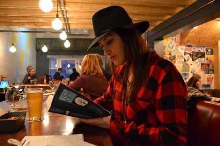 Books and beer – has there ever been a better combo? The Good Robot Brewing Company is inviting its patrons to bring their books to the bar once a month for their two-hour silent reading event. [Photo: Craig Muise]