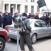 Police line up to protect the hotel and contain protesters