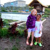 After the end of season cornboil, and party (thanks to members of the wonderful Gypsophilia) cousins stand by the new sign. 