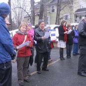 A crowd gathers around the oil drum to sing climate change carols.