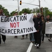 C. J. Hamilton and Chris Whynder carry a banner through Halifax's north end Saturday (Photo: Hilary Beaumont)