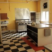 One of two kitchens. That's a full range on the far wall. The room next door has a walk-in freezer.