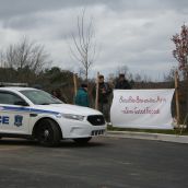 Two police cruisers kept an eye on the forty or so mostly greying residents, just in case.  Photo Robert Devet