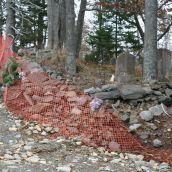 Remnants of a cemetery wall that caved in when bulldozers came in to build the new access road. Photo Robert Devet