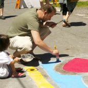 Mark and his daughter Morgan painting the mural in their neighborhood.