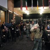 The assembled media faces...