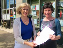Megan Leslie, M.P. for Halifax receiving petition from Joanne Light, Citizens' Climate Lobby Halifax, demanding the government act deeply and broadly on climate change