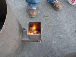 A characteristic of rocket stoves: the fire goes down, into the burn chamber, due to the draw